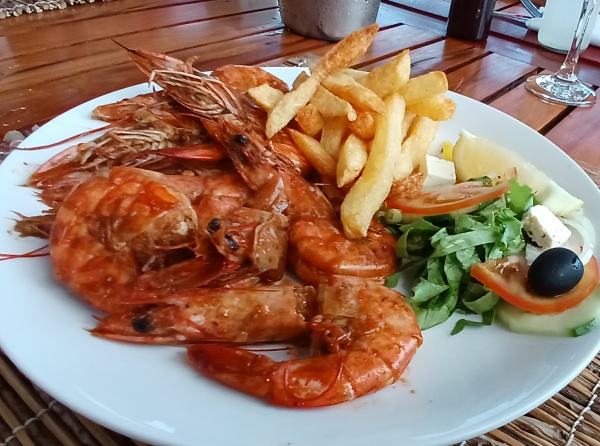 Grilled Mozambican prawns fresh seafood dish at The Captain's Table restaurant in Barra Inhambane